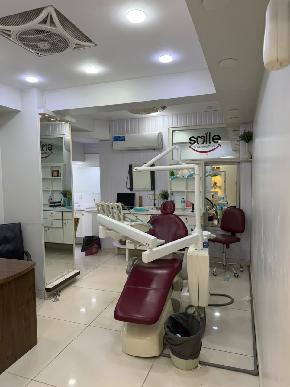 Maroon dental chair and clinical equipment in a Smile by Alkhaleej treatment room